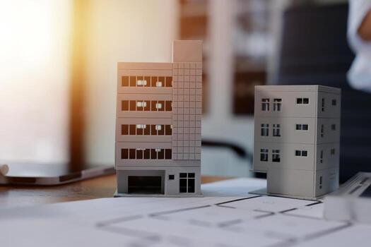 A man is looking at a model of a building photo