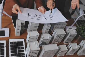 Two people are looking at a blueprint of a building photo