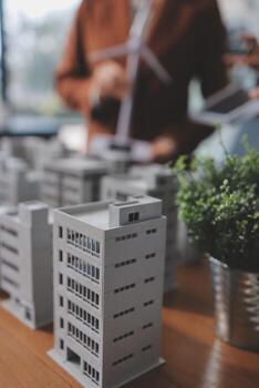 A man is looking at a model of a building photo