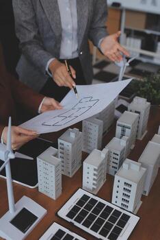 Two people are working on a project with a blueprint photo