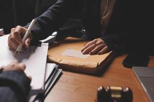 A business person signing papers at a desk photo