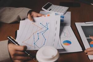 Business people working on graphs and papers photo