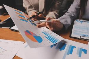 Business people working on graphs and papers photo