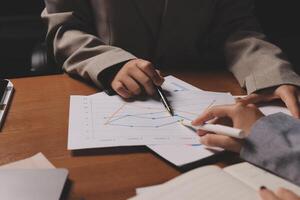 Business people working on graphs and papers photo