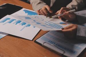 Business people working on papers with graphs and papers photo