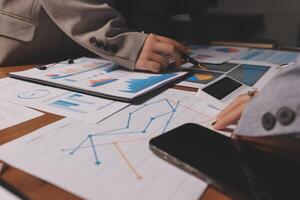 Business people working on papers and graphs photo