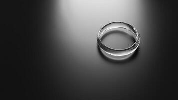 A clear ring is on a black background. The ring is not visible in the foreground photo