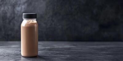 Brown beverage in a glass bottle set against a textured dark background. Ideal for showcasing nutrition, health, and tasty drink options in various settings. photo