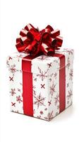 White box with red ribbon and snowflake designs. The box is a gift and is placed on a white background photo