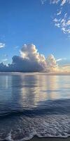 Captivating ocean scene with dramatic clouds and serene reflections at sunset, showcasing nature's beauty. photo