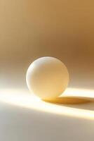 A simple and elegant image of a white sphere casting a shadow on a gradient beige background, showcasing minimalist design. photo