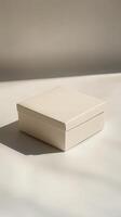 White box sits on a white surface. The box is empty and has a plain design. Concept of simplicity and minimalism photo
