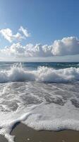 The ocean is calm and the sky is blue. The waves are small and the water is clear photo