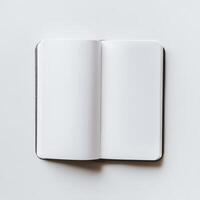 A top-down view of an open blank notebook on a white surface, ideal for themes of creativity, planning, or minimalism. photo