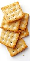 A close-up of crispy salted crackers stacked photo