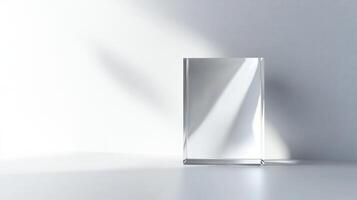 A clear glass box is sitting on a white table. The box is empty photo