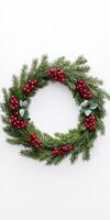 Wreath with red berries and green leaves. The wreath is circular and has a festive feel to it photo