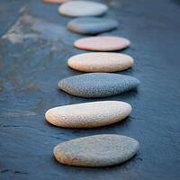 Close-up of smooth pebbles on slate, showcasing natural textures and calming arrangement. photo