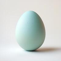 A Single Pastel Blue Egg on White Background, Minimalist Easter Concept photo