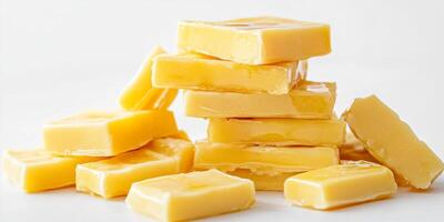 Freshly Cut Yellow Soap Bars Stacked on White Background photo