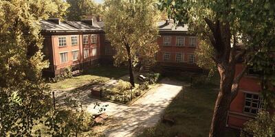 Peaceful courtyard with historic red brick buildings and lush trees, bathed in sunlight, creating a tranquil urban oasis. photo