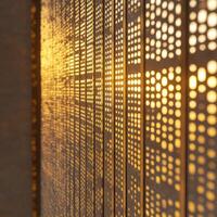 Sunlight casts a warm glow through perforated metal panels, forming a captivating geometric design. photo