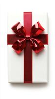 White box with a red bow on it. The bow is shiny and metallic photo