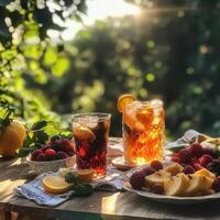 Table with two glasses of tea and fruit on it. Scene is relaxed and inviting photo