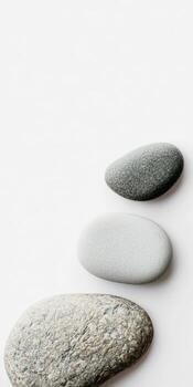 Three rocks are stacked on top of each other. The rocks are white and gray photo