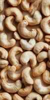 A close-up view of raw cashew nuts arranged on a brown background, showcasing their unique shape and texture, perfect for healthy snacks or nutritious recipes. photo