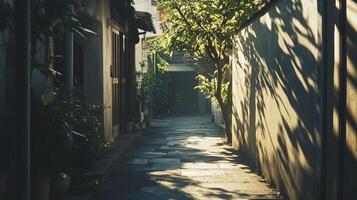 A peaceful alleyway bathed in sunlight, featuring lush greenery and rustic architecture, creating a tranquil urban escape. photo
