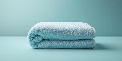 A neatly folded blue towel on a pastel background, perfect for themes of relaxation, spa, and home decor. photo