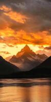 Majestic Mountain Sunset Over a Serene River photo