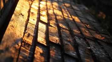 A close-up view of weathered wooden planks illuminated by soft sunlight. The warm glow creates beautiful shadows, enhancing the rustic charm of nature. photo