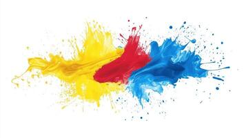 A splash of paint with yellow, red, and blue colors. The colors are splattered across the white background photo