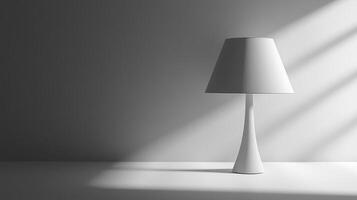A lamp is sitting on a table in front of a wall. The lamp is white and has a shade photo
