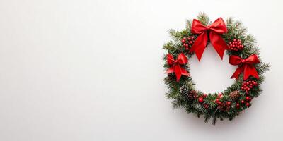 Festive Christmas Wreath with Red Bows and Berries on Minimalist White Background photo