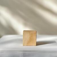 Minimalist Wooden Cube on White Surface with Soft Shadows and Neutral Background photo
