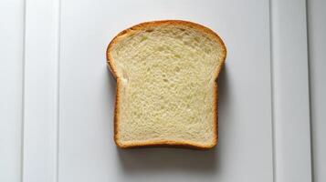 Slice of white bread is shown on a white background photo