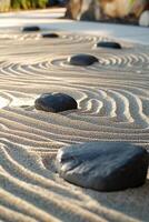 Tranquil Zen Garden with Smooth Stones and Raked Sand Patterns in Serene Outdoor Setting photo