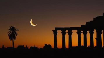 The crescent moon is seen in the sky over the ruins of an ancient city photo