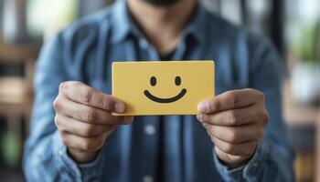 Person Holding Yellow Smiley Feedback Card photo