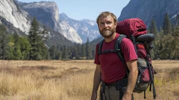 Smiling Hiker with Backpack in Mountain Valley photo