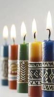 Colorful Lit Candles with Decorative Bands on White Background photo