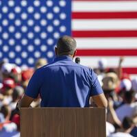 Man Delivering Speech at Outdoor Event with American Flag photo