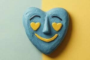 Teal Heart Shaped Artwork with Yellow Smiling Face photo