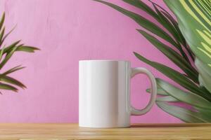 White Mug Mockup on Wooden Table with Tropical Leaves photo