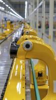 Yellow Industrial Robots on Conveyor Belt in Modern Factory photo