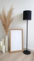 Elegant minimalist interior design featuring a blank frame for personalized art or photography, complemented by pampas grass in a white ceramic vase, creating a soft, natural aesthetic Illuminated by photo