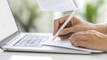 Elevate your content creation with a captivating image of hands poised to write on paper alongside a sleek laptop, symbolizing innovation and productivity Explore the dynamic intersection of photo